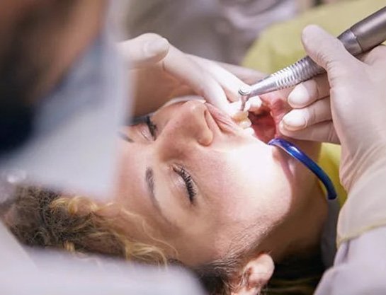 Dentist performing dental bonding treatment