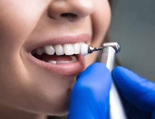 A dentist closely examining their patient’s teeth