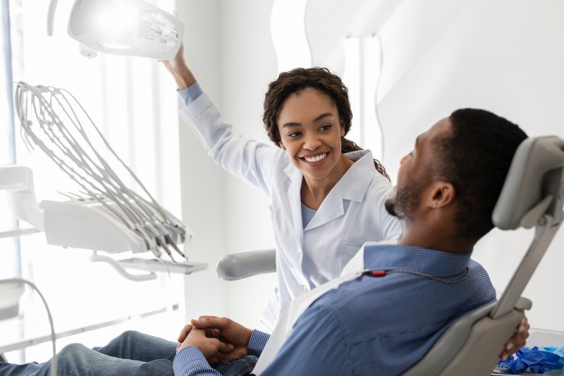 Patient smiling at dentist while discussing dental checkups